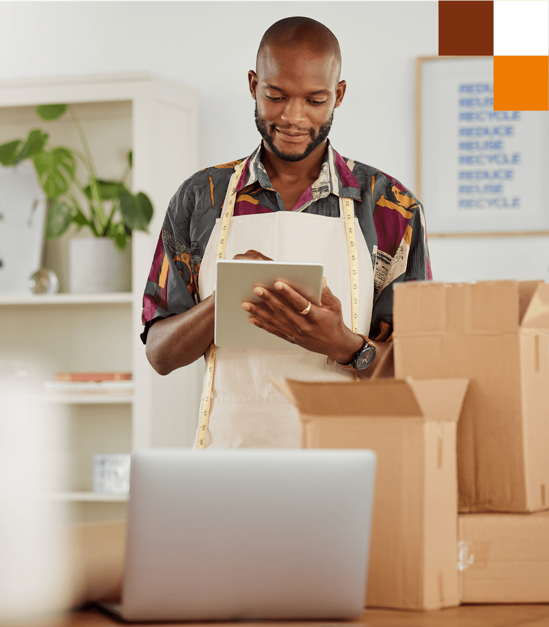 A man using a tablet to manage an online business