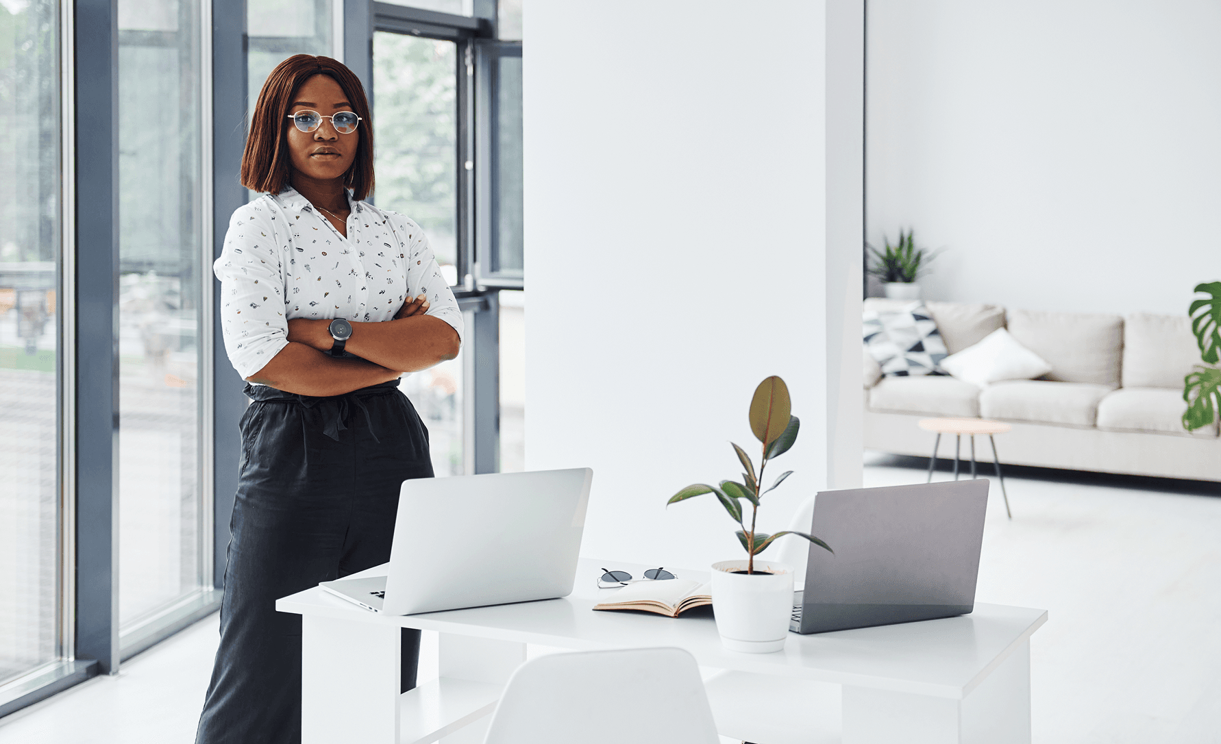 An image of a woman standing in a corporate office